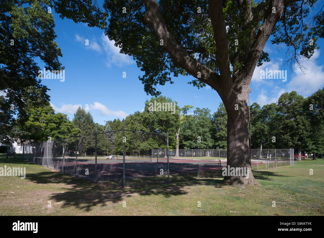Vacant tennis courts on a summer morning in Whitehall, Michigan. Stock Photo