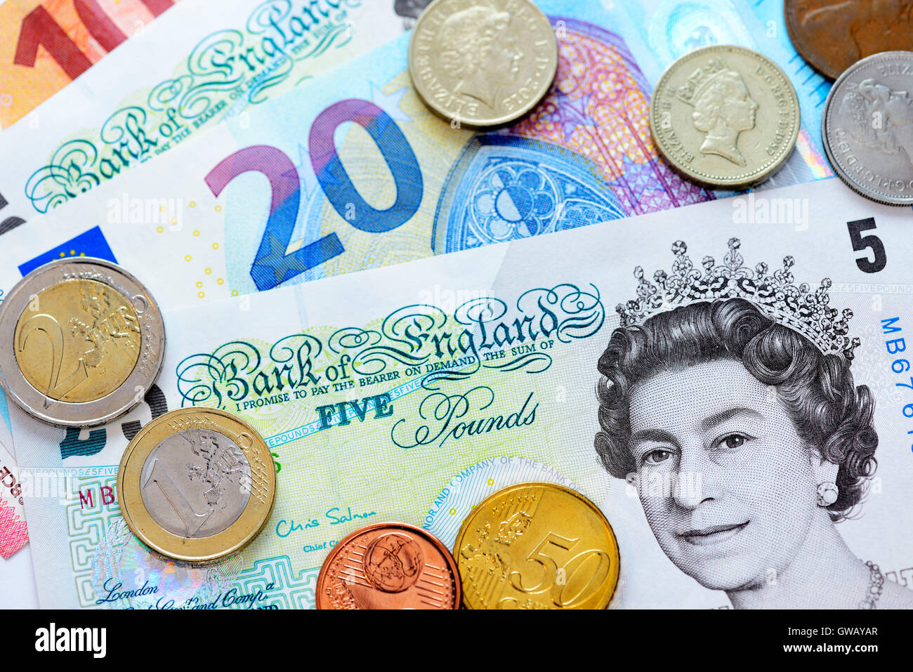 British pound marks and euro-bank notes and Euro monetary coins, Britische Pfundnoten und Euro-Geldscheine und -Geldmuenzen Stock Photo