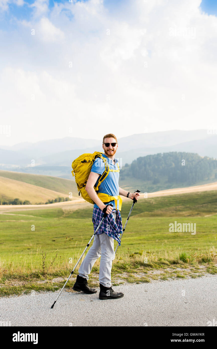 Young man hiking and goes Stock Photo