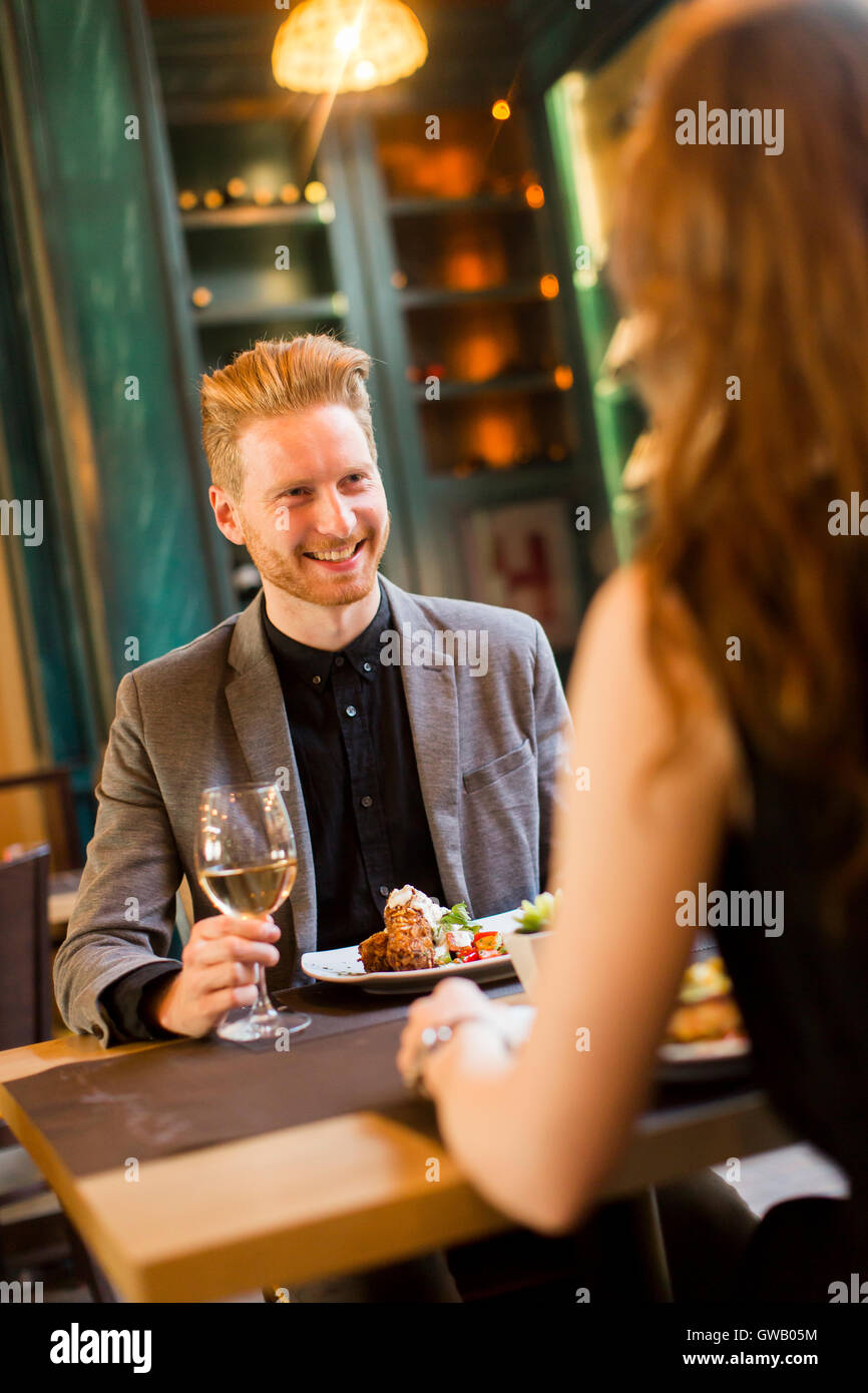 Handsome young redhair couple having dinner in the restaurant Stock Photo