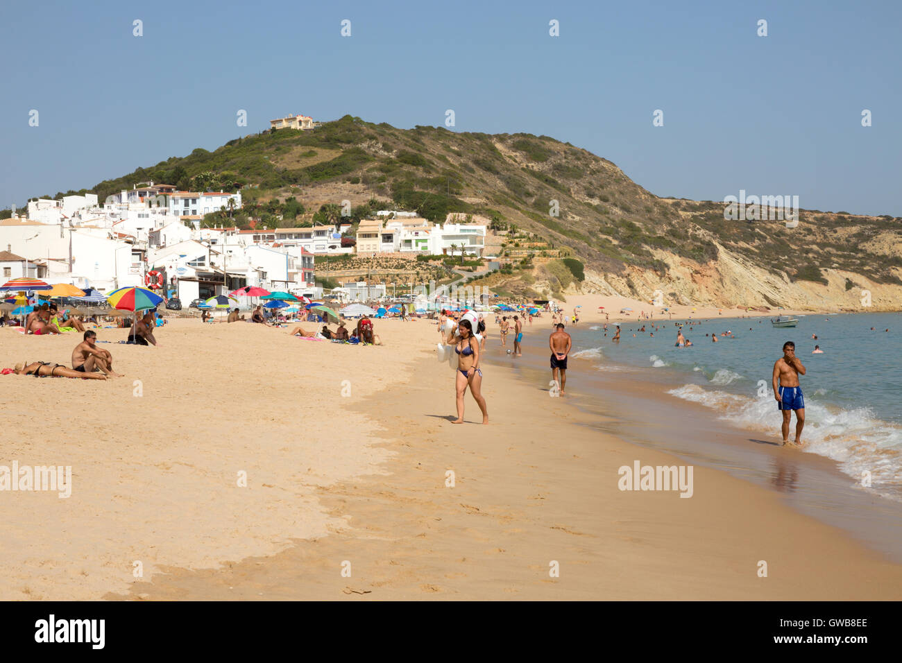 People on the beach at Salema, Algarve, Portugal, Europe Stock Photo