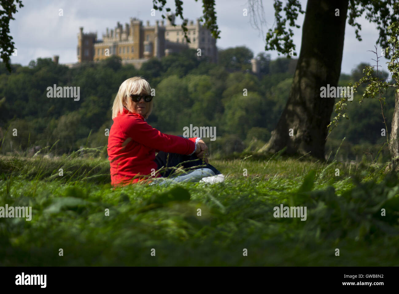 middle age woman sitting resting during country walk Stock Photo