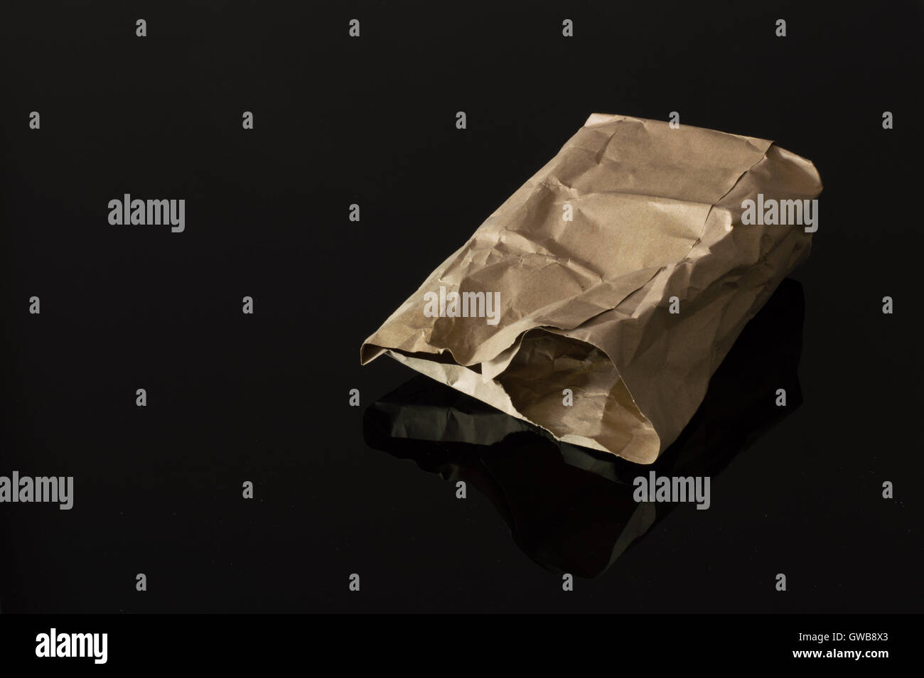 Brown Paper Bag Isolated on Dark Background Stock Photo