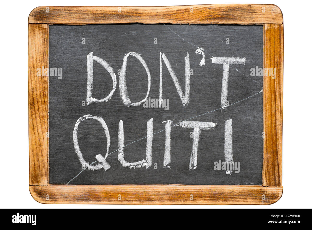 don’t quit phrase handwritten on vintage school slate board isolated on white Stock Photo