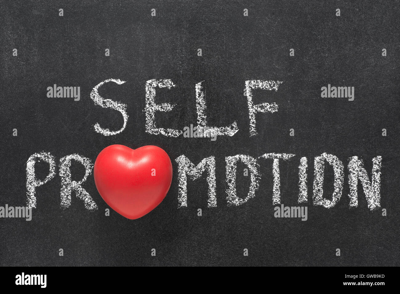 self promotion phrase handwritten on chalkboard with heart symbol instead of O Stock Photo