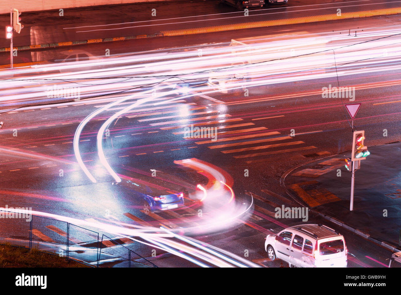 Night urban city scene: crossroads at Moscow (Russia) with cars driving to different direction forming a light pattern. Stock Photo