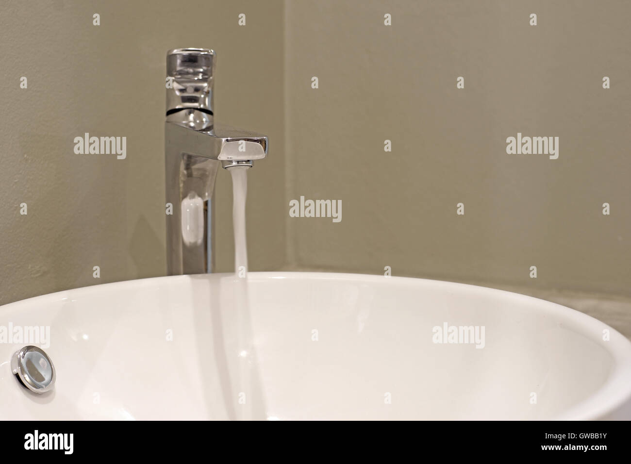bathroom sink with running water from faucet Stock Photo Alamy