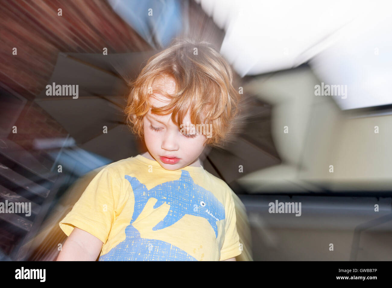 Image of a young 3-year old boy in the garden using slow-sync flash technique Stock Photo