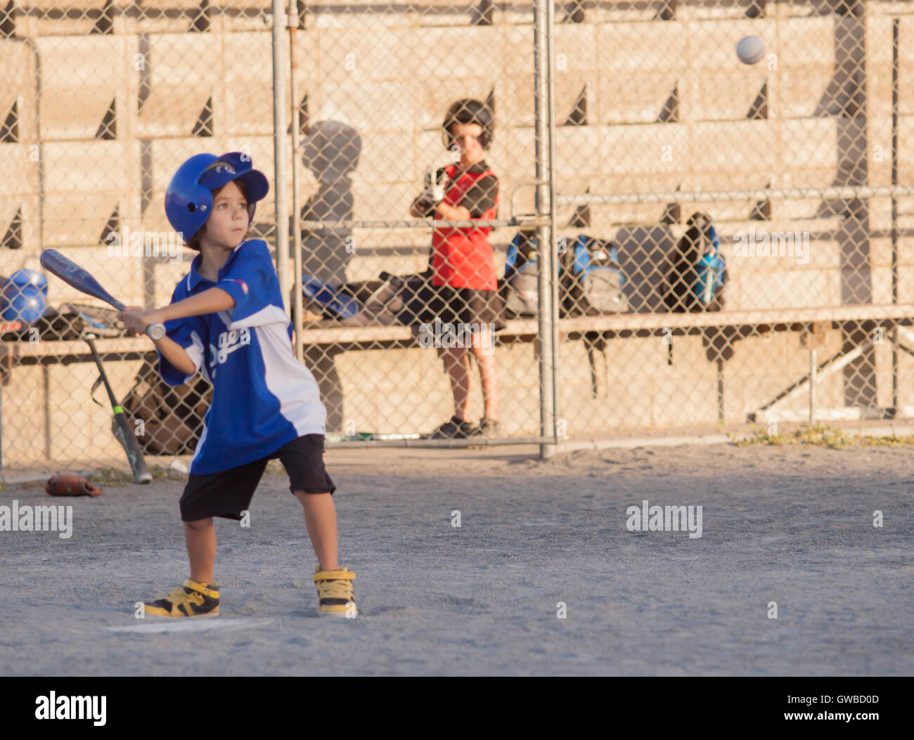 A young boy has batting practice during a training session for baseball