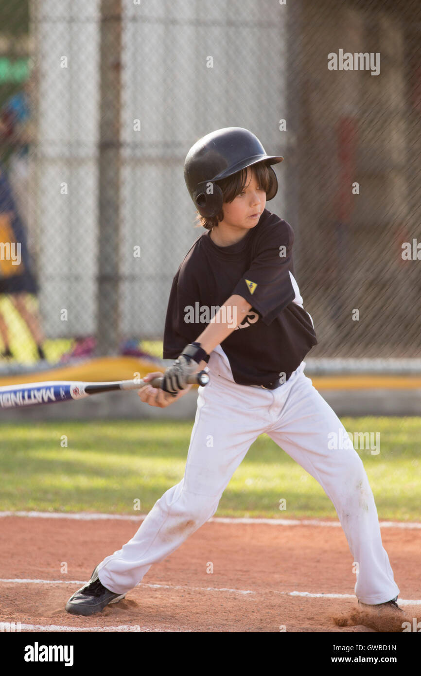 A young boy bats during a baseball game in Cairns, Australia Stock Photo Alamy