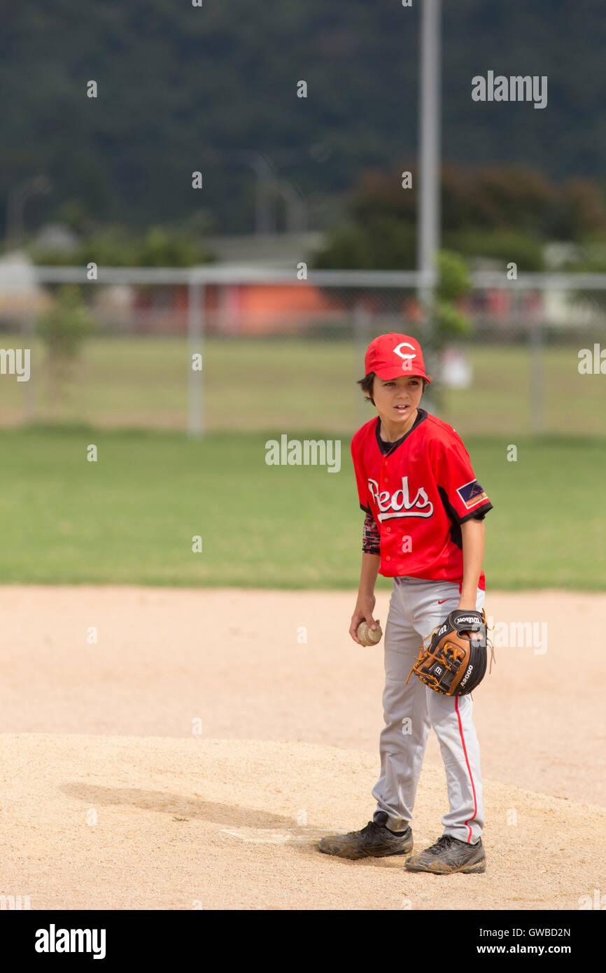 A teenage boy pitches during a baseball game in Cairns, Australia Stock
