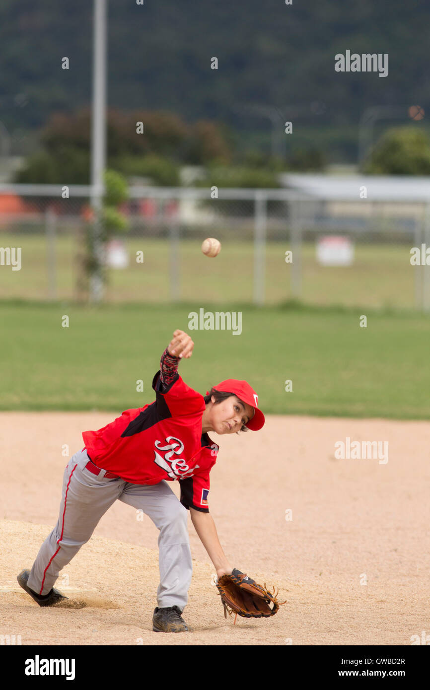 A teenage boy pitches during a baseball game in Cairns, Australia Stock