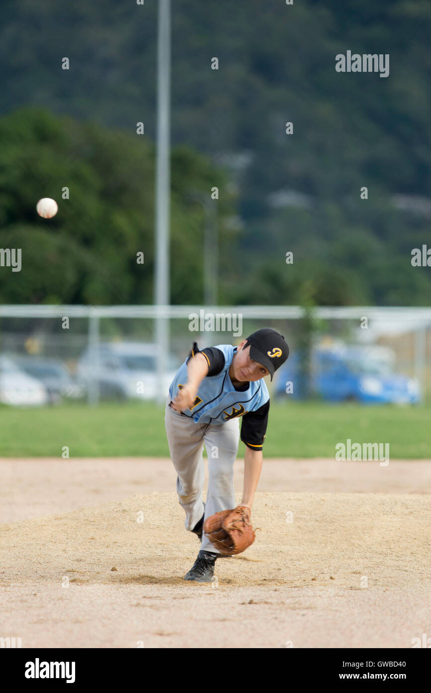 A teenage boy pitches during a baseball game in Cairns, Australia Stock