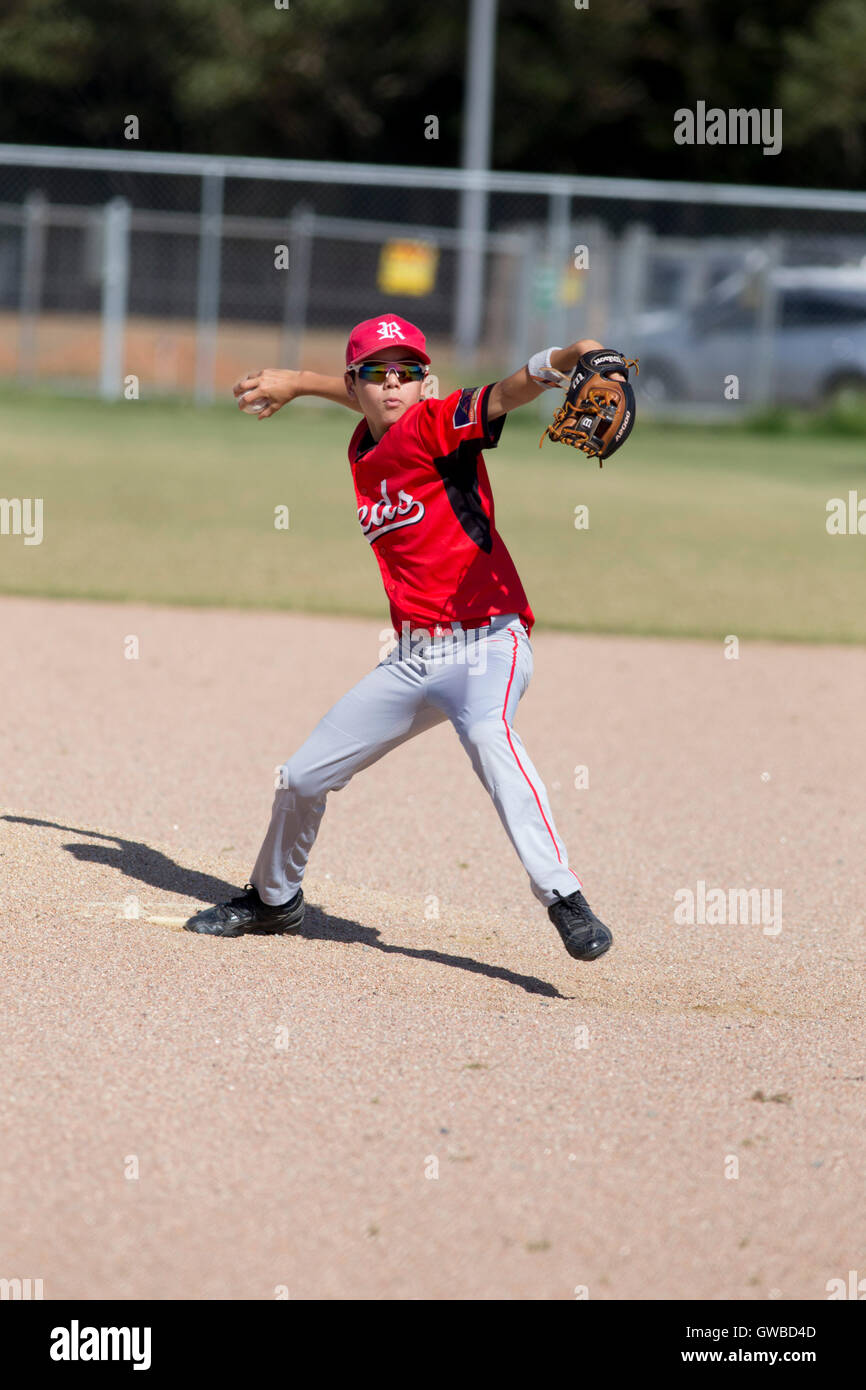 A teenage boy pitches during a baseball game in Cairns, Australia Stock