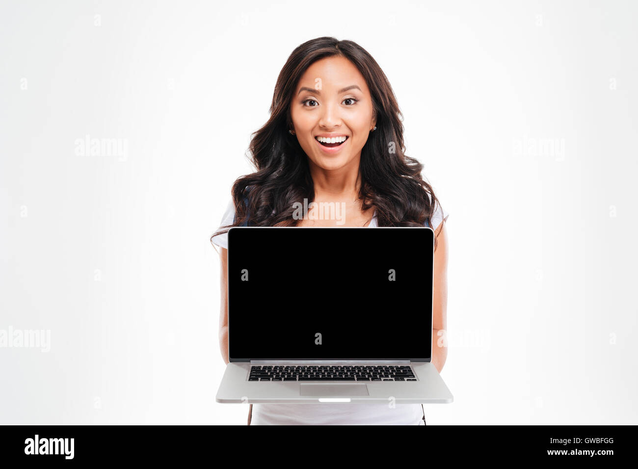 Happy smiling beautiful asian woman holding laptop with blank screen ...