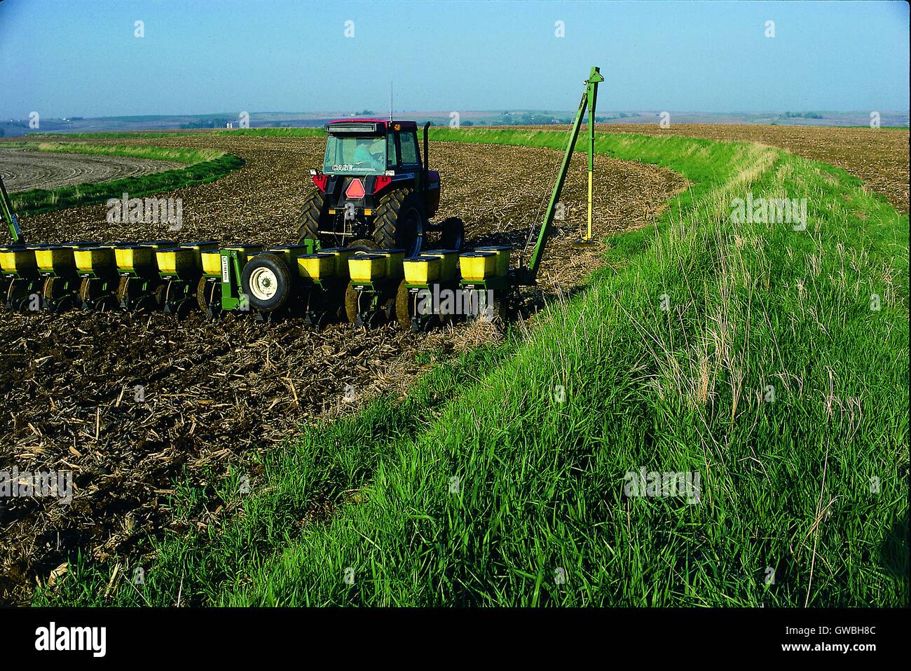 A farmer plants corn using conservation tillage methods on terraced land at Gil Winter Farm in Plymouth County, Iowa. Stock Photo