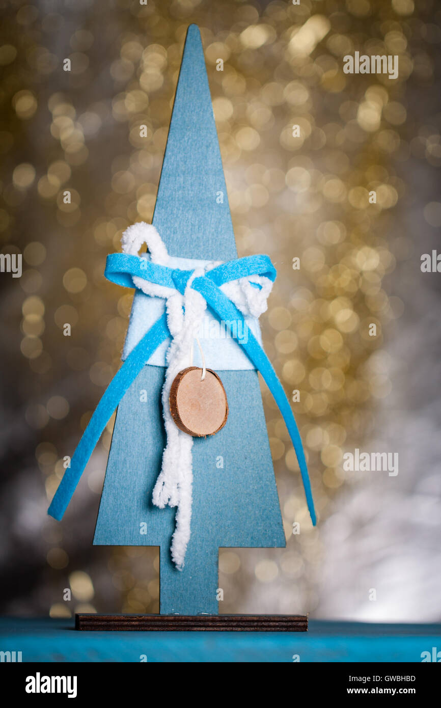 Wooden christmas tree on gold bokeh background. Decorative xmas card. Stock Photo