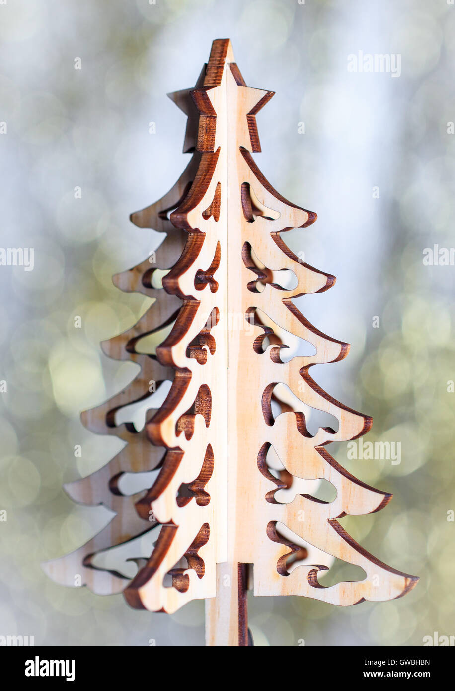 Wooden christmas tree on gold bokeh background. Decorative xmas card. Stock Photo