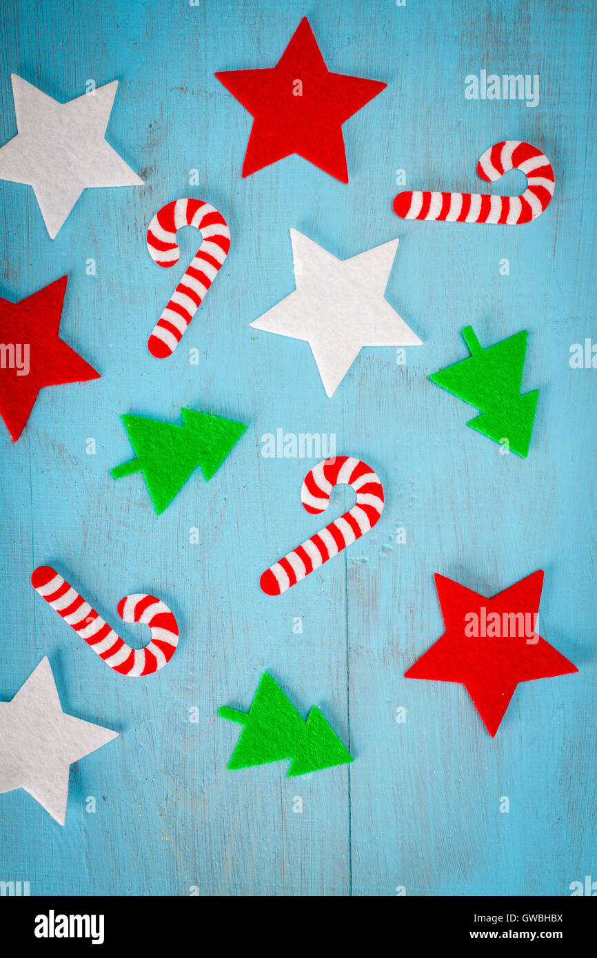 Christmas background of flat lay felt decoration on blue wooden table. Stock Photo
