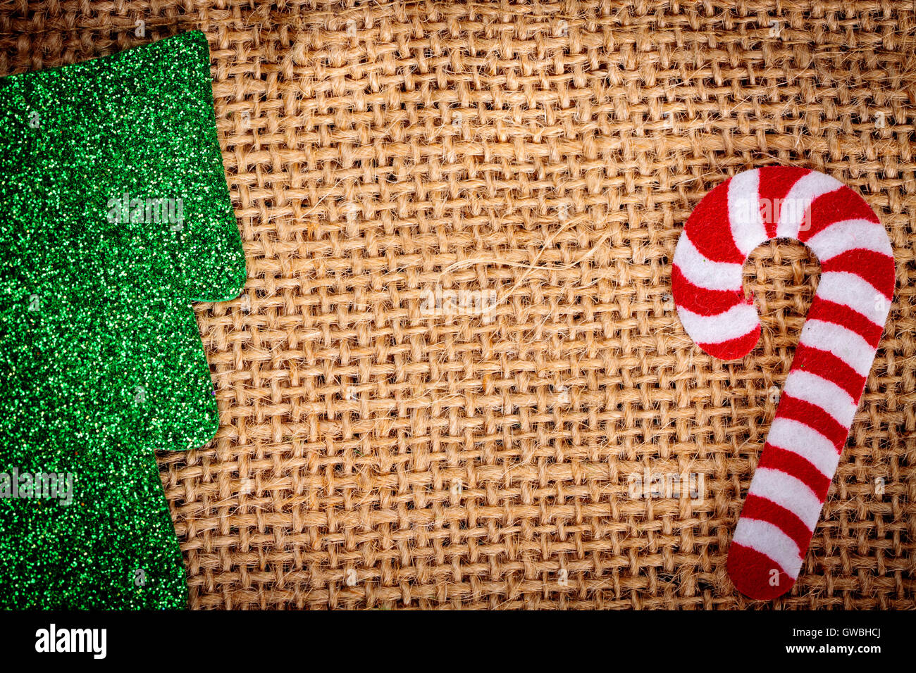 Felt christmas decorations on jute background with copy space. Stock Photo