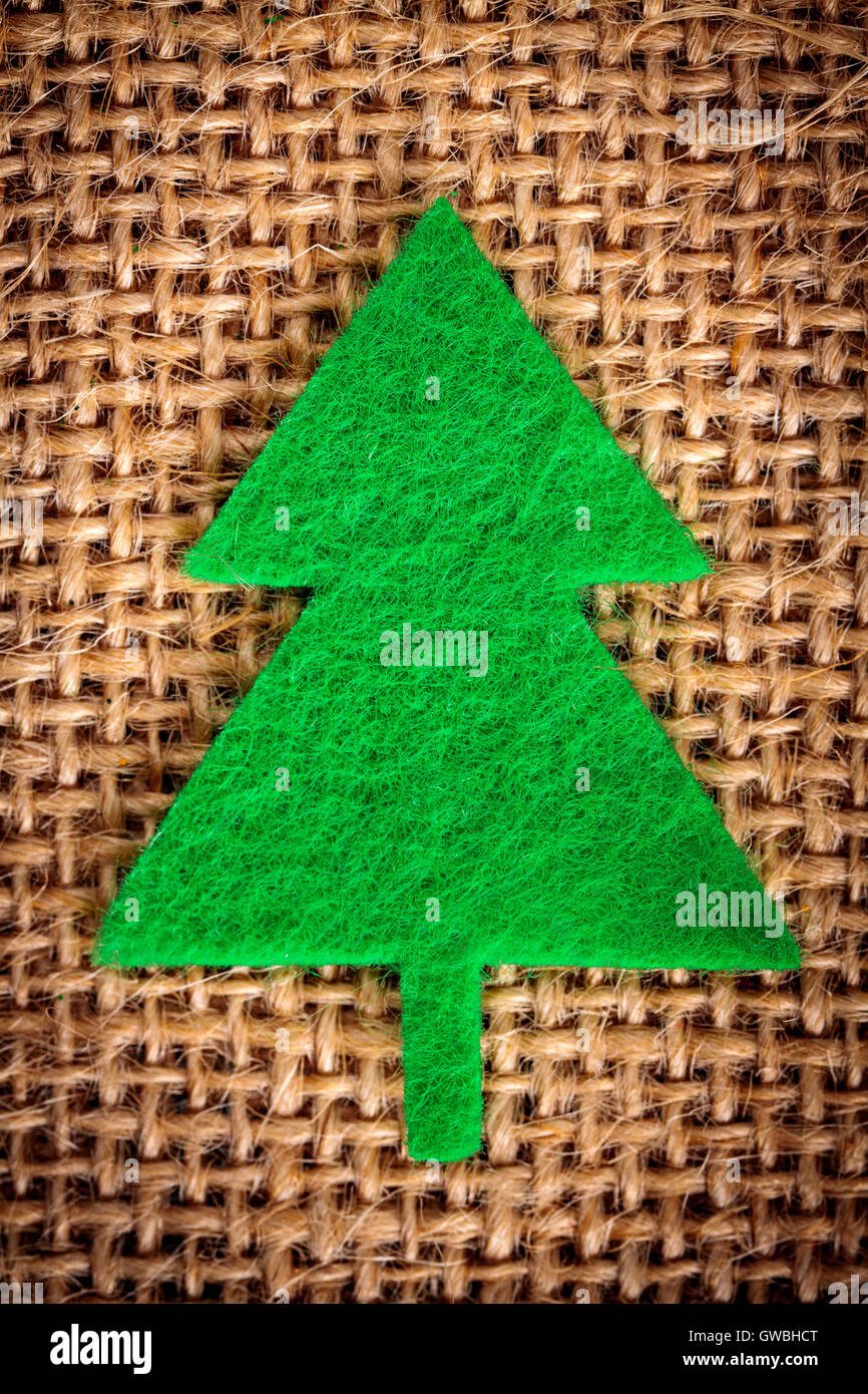 Felt christmas decorations on jute background. Stock Photo