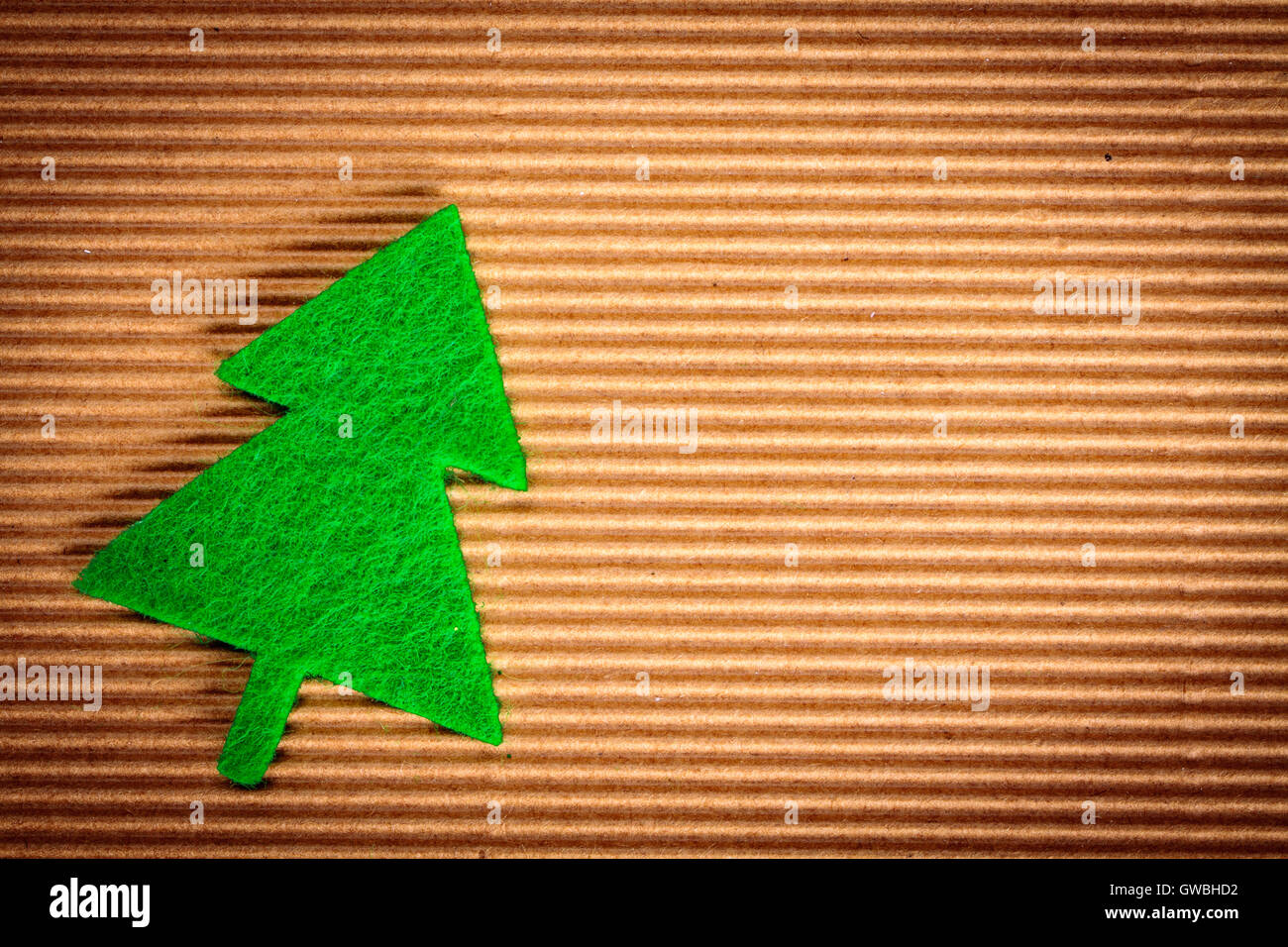 Felt Xmas decoration on recycled cardboard background with copy space. Stock Photo