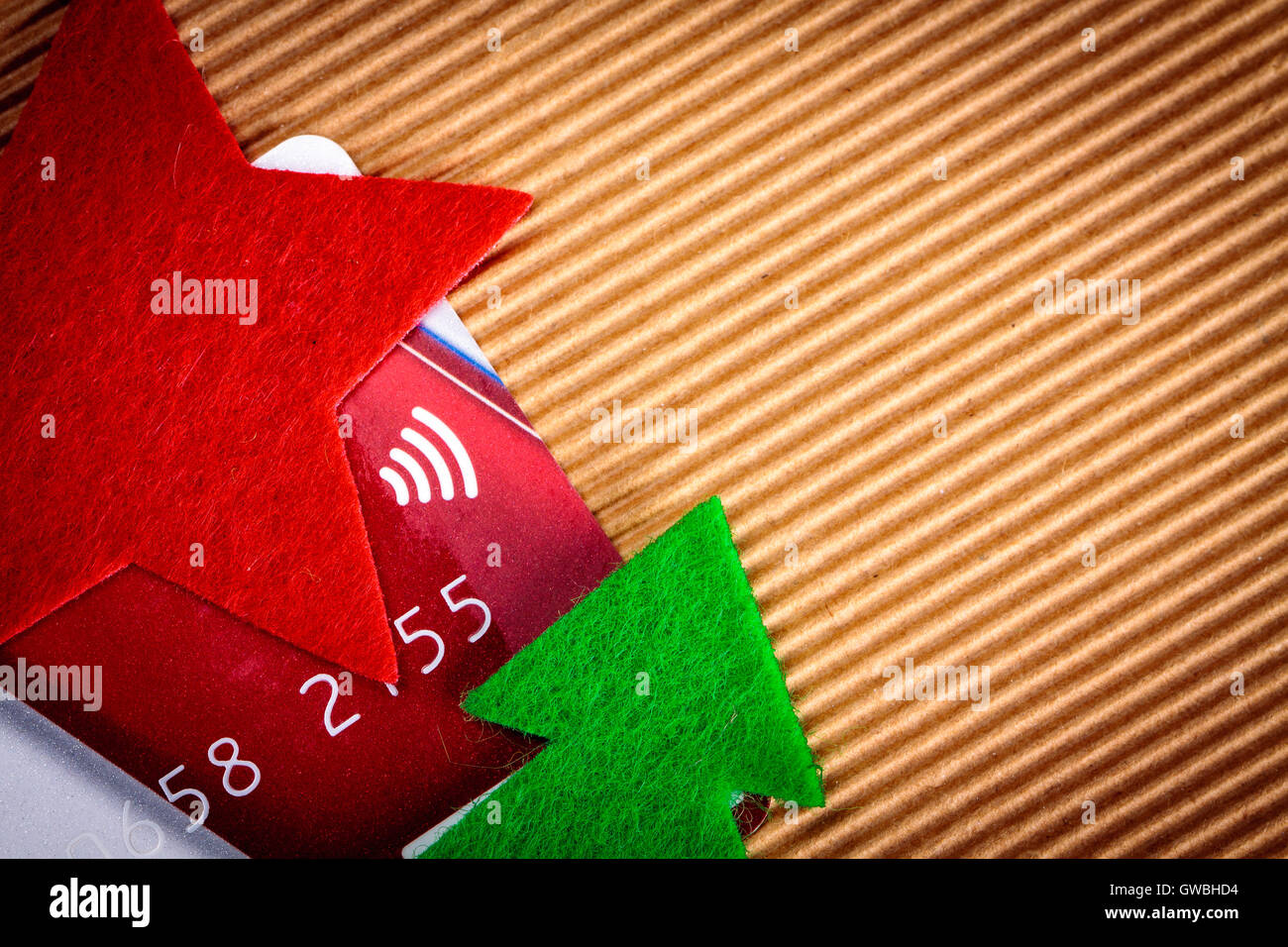 Credit card and felt christmas decoration on paper. Stock Photo