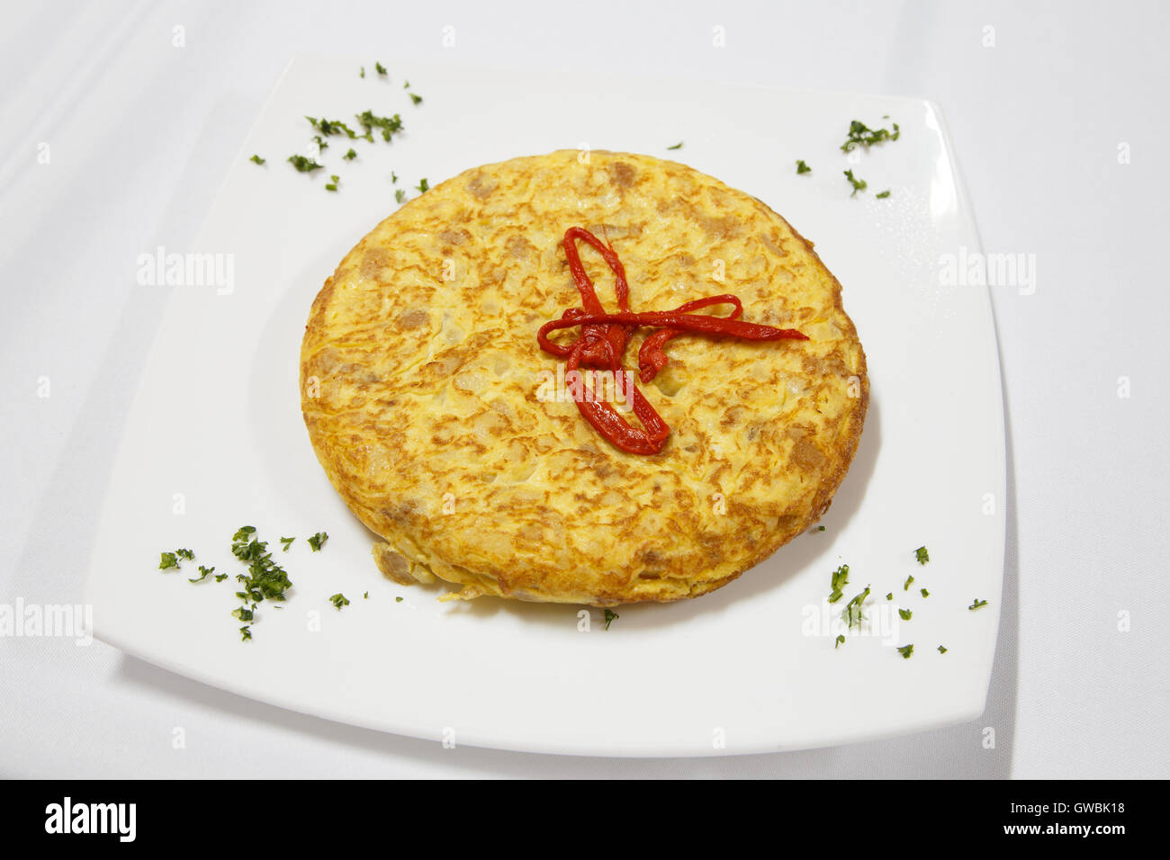 Spanish cuisine. Potatoes omelet served with pepper.Tortilla espanola. Stock Photo