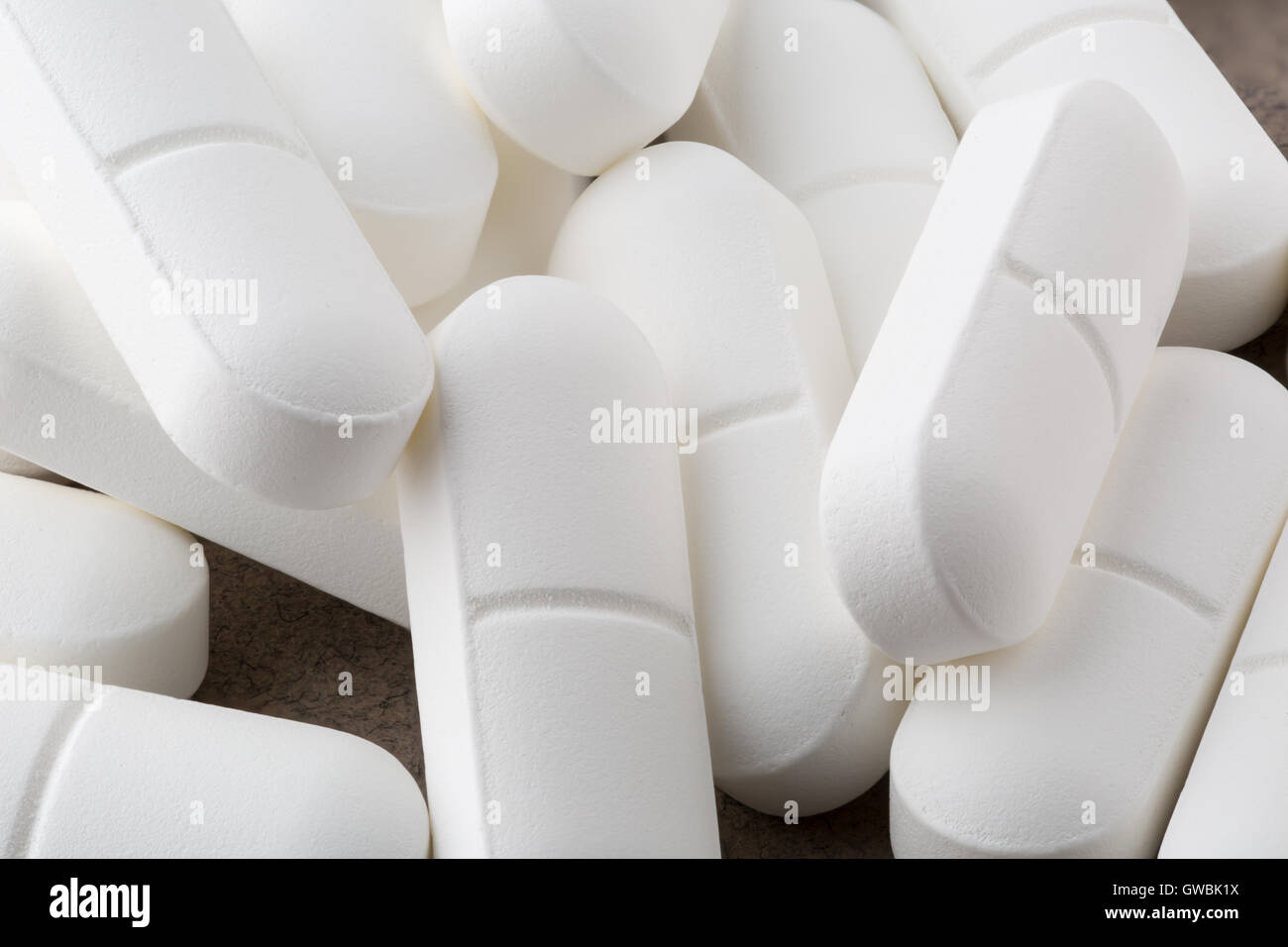 Heap of antibiotic white pills. Closeup Stock Photo