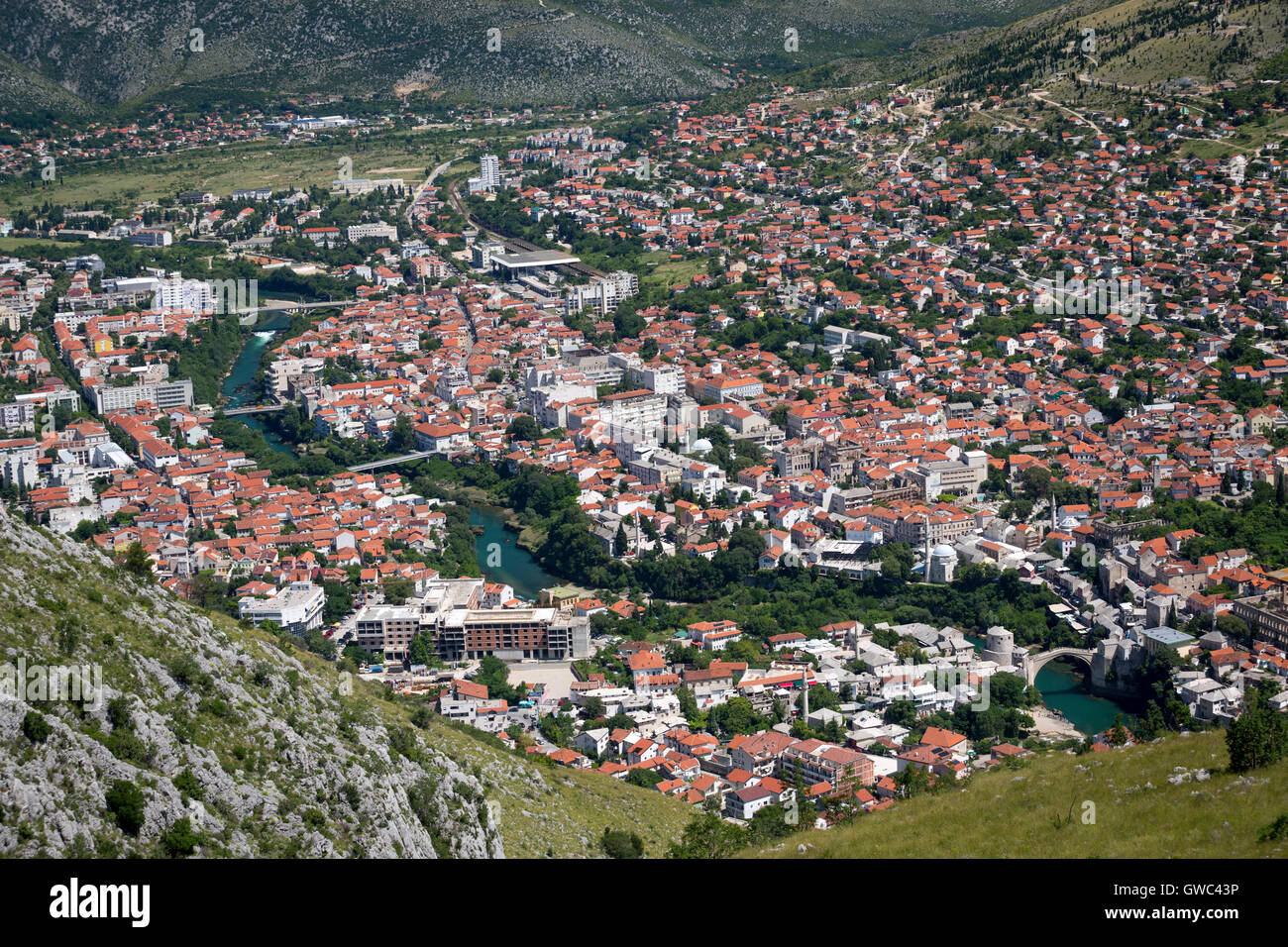 An aerial view of Mostar (Bosnia Herzegovina) cut by the Neretva river with old town of Mostar and old bridge in the foreground. Stock Photo