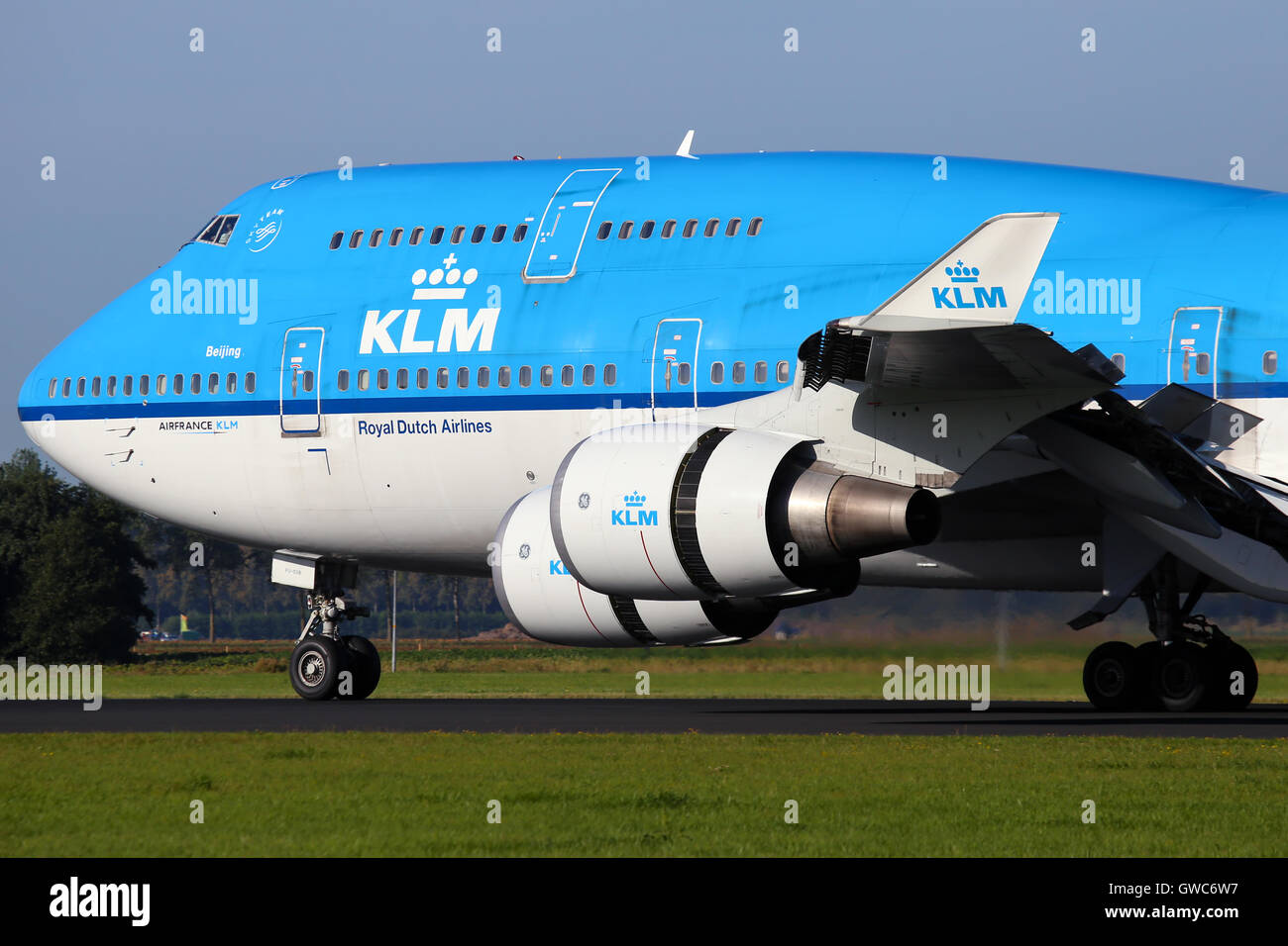 KLM Royal Dutch Airlines Boeing 747-400 touches down on runway 18R at Amsterdam Schipol airport. Stock Photo