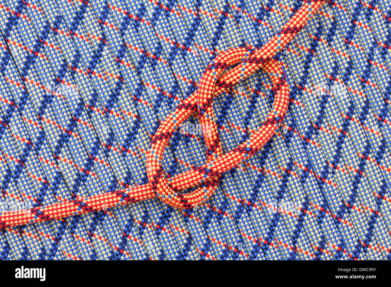 Bright colored rope with a figure-eight knot on a background of ropes Stock Photo
