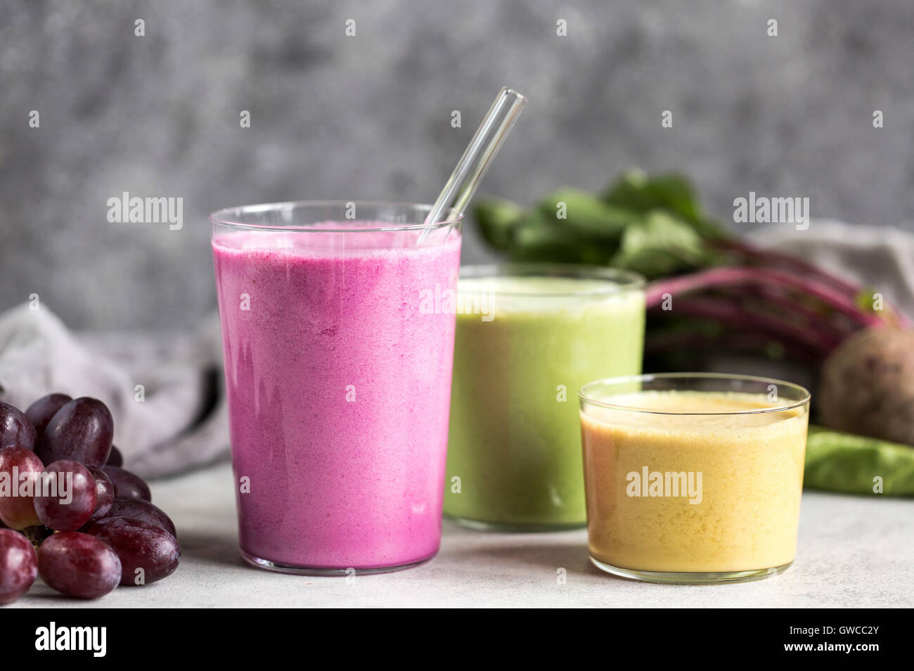 3 glasses of Multi-Colored Beet Smoothies are photographed from the front view. Stock Photo