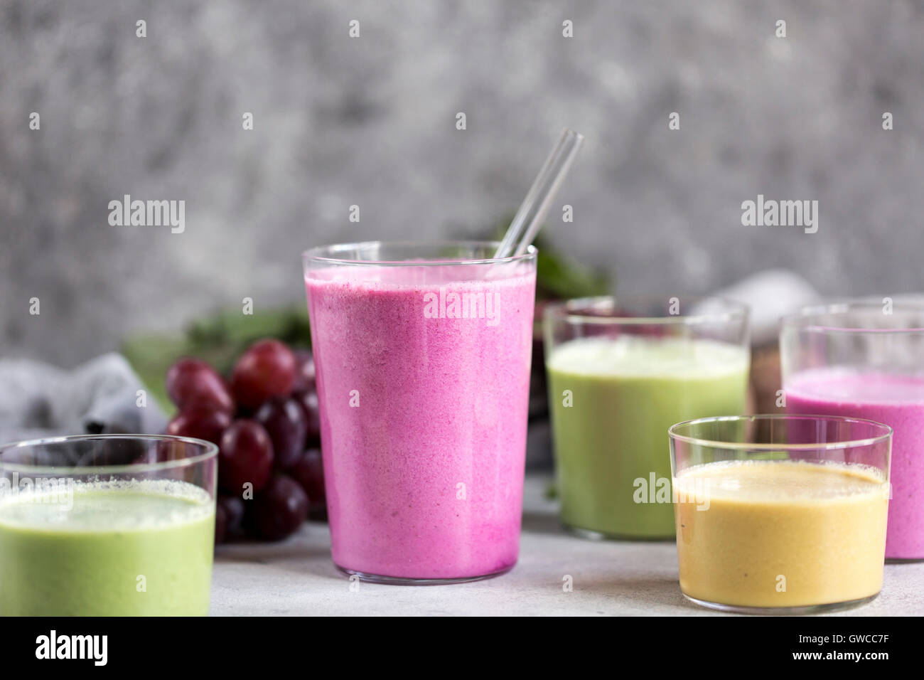 Several glasses of Multi-Colored Beet Smoothies are photographed from the front view. Stock Photo