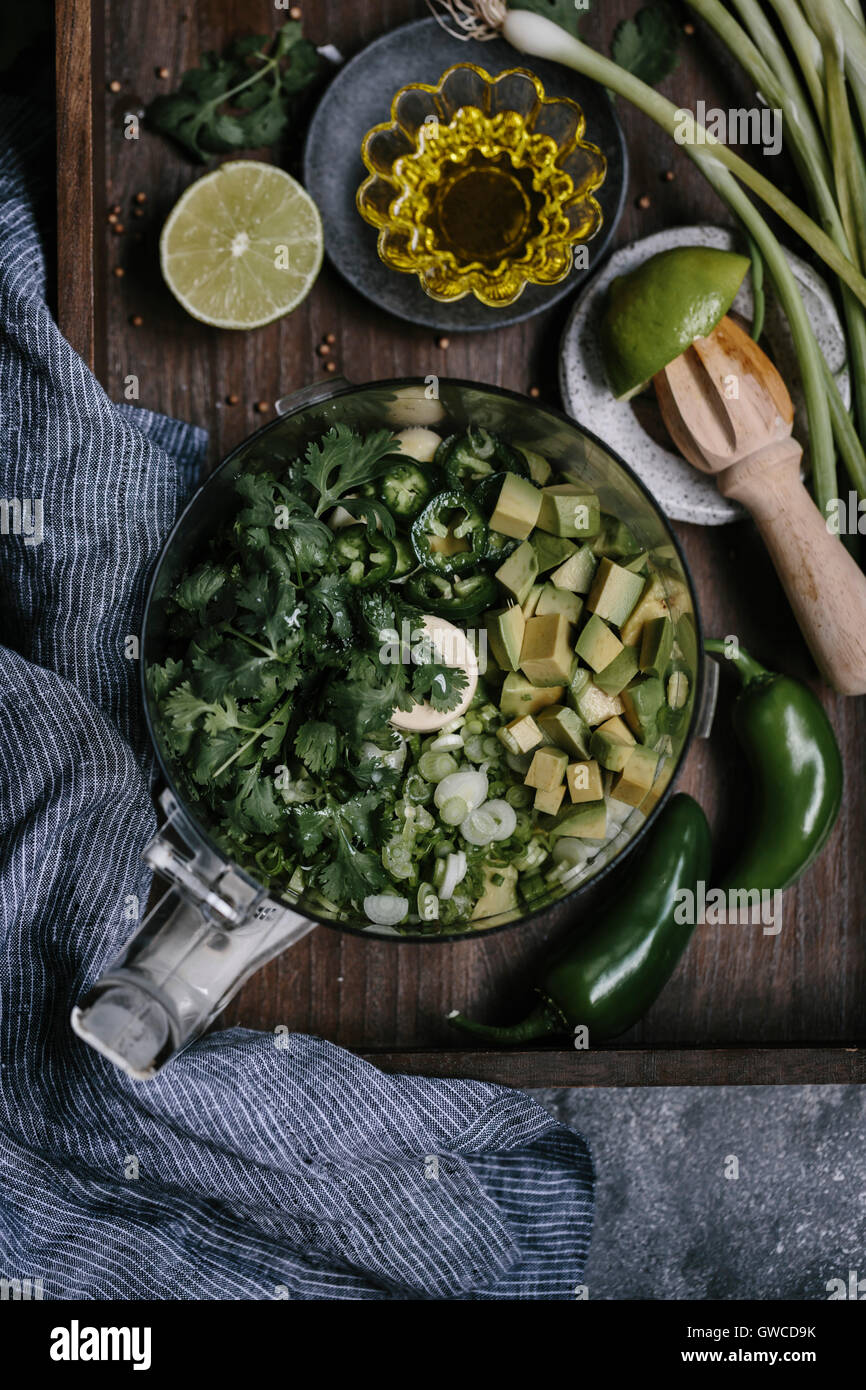 Ingredients for Creamy Avocado Salad Dressing are placed in a food