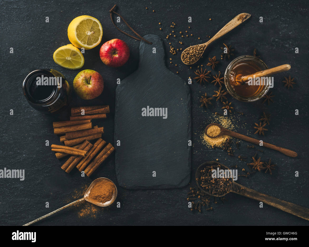 Ingredients for making mulled wine. Wine in glass bottle, honey, lemon