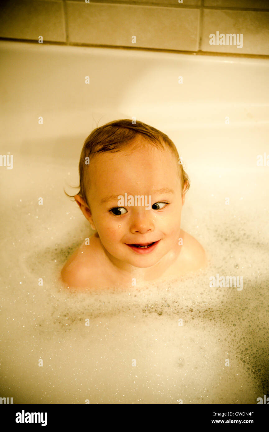 One year old boy playing in a bath tub Stock Photo Alamy
