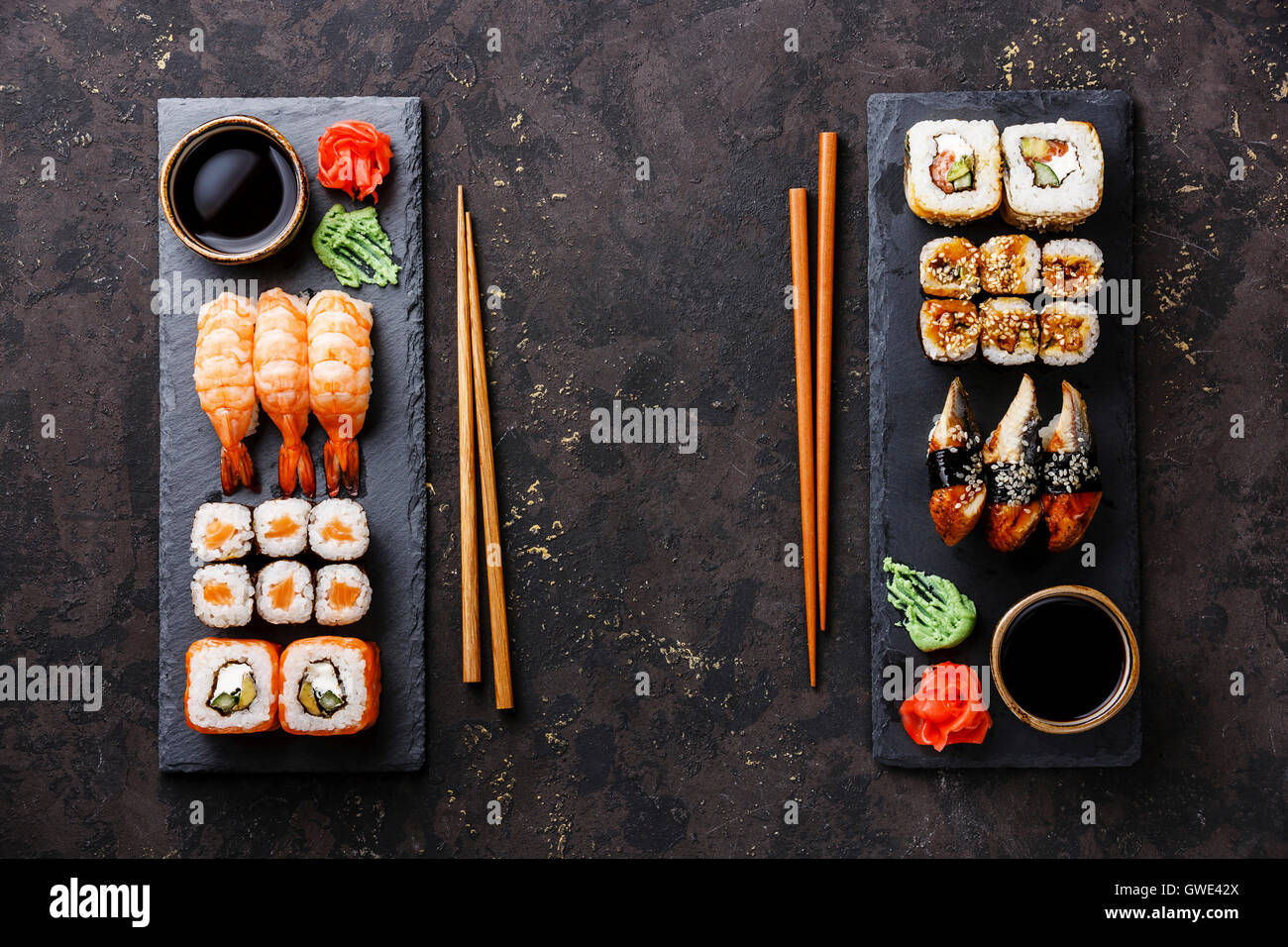 Sushi rolls, maki, nigiri Set served for two on black stone slate on dark background Stock Photo