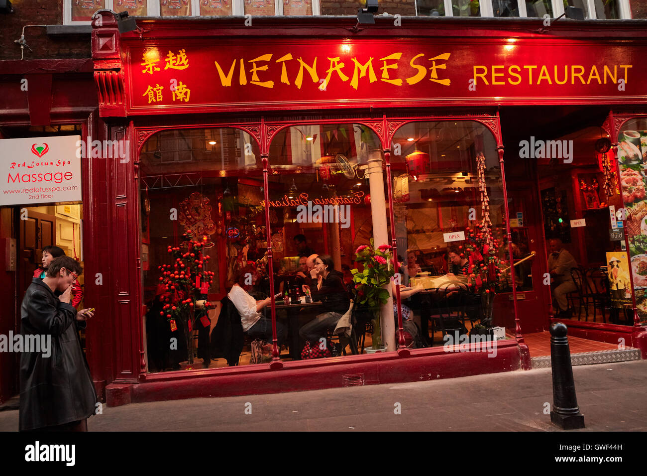 Chinatown in Londone.Spring  2011. Vietnamese restaurant with visitors. Through the large windows you can see  visitors of the resaurant. Stock Photo