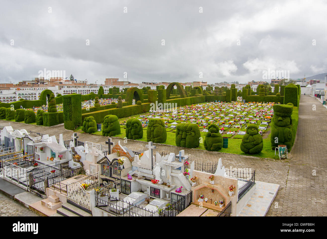 TULCAN, ECUADOR - JULY 3, 2016: aerial view of the cemetery, plants sculptures surrounding some graves Stock Photo