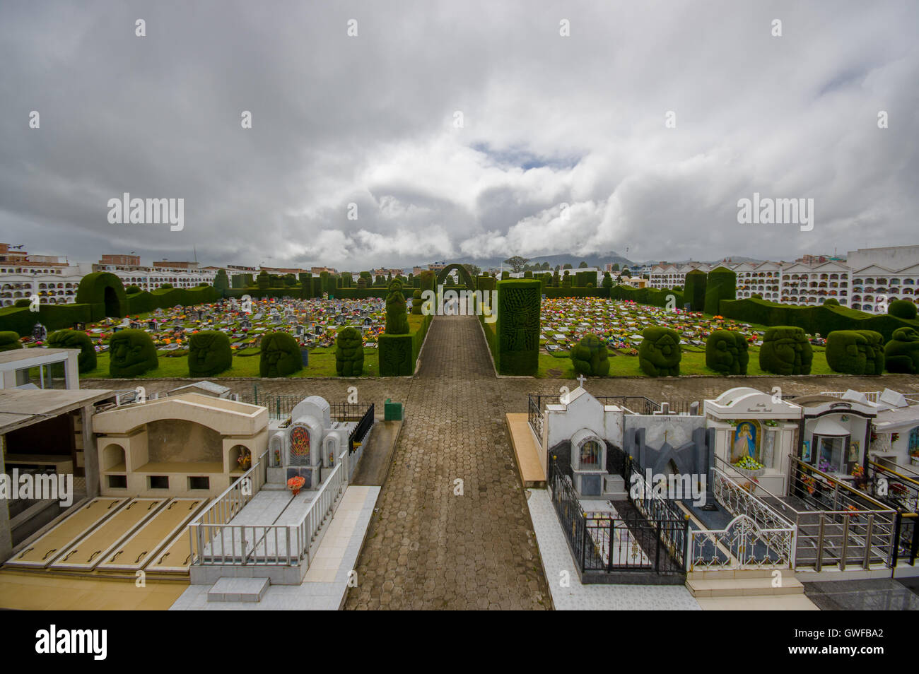 TULCAN, ECUADOR - JULY 3, 2016: nice overview of the gardens of the cemetery, nice plants sculptures surrounding graves Stock Photo