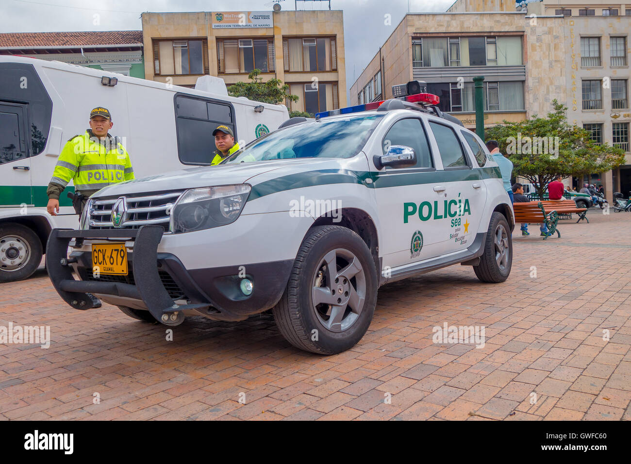 PASTO, COLOMBIA JULY 3, 2016 unidentified police officers standing next to a police car