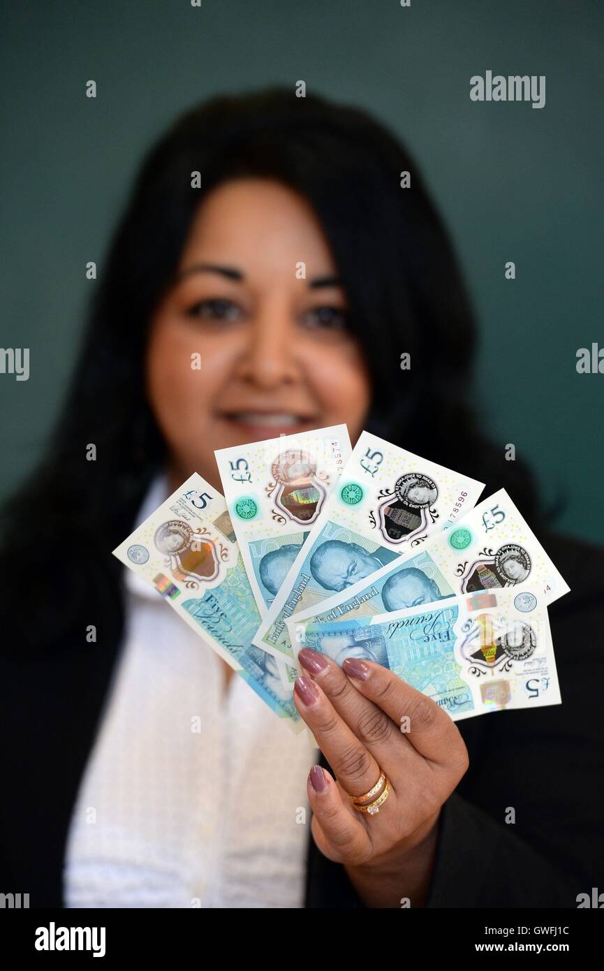 Cash Machine Raju Kam Raju holds some of the first polymer £5 notes issued by the Bank of ...