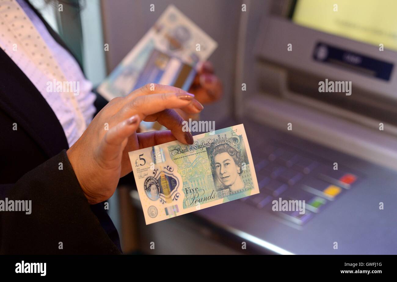 Cash Machine Raju Kam Raju holds one of the first polymer £5 notes issued by the Bank of ...