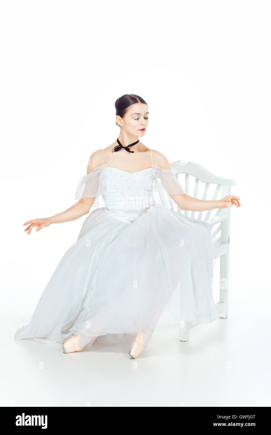 Ballerina in white dress sitting, studio background Stock Photo - Alamy