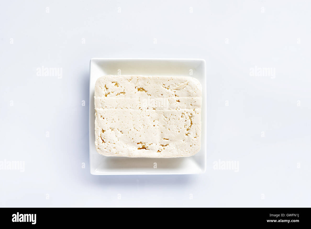 Tofu on a white plate on a white table, fresh vegetarian food, meat substitute Stock Photo Alamy