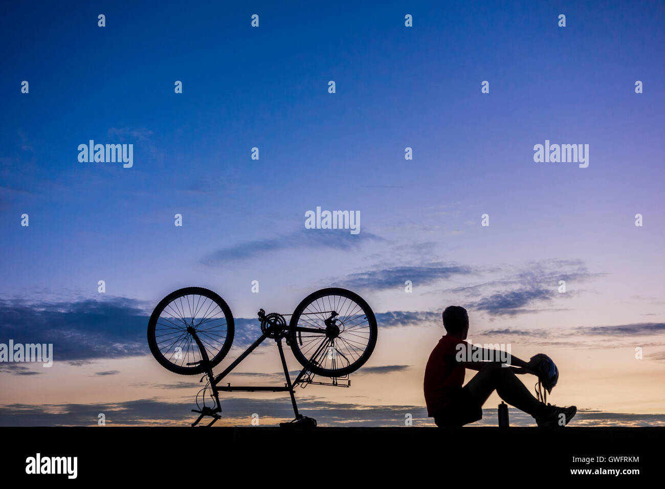 Mountain biker silhouetted at sunrise. UK Stock Photo