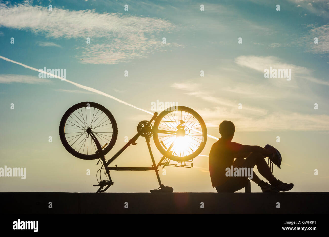 Mountain biker silhouetted at sunrise. UK Stock Photo