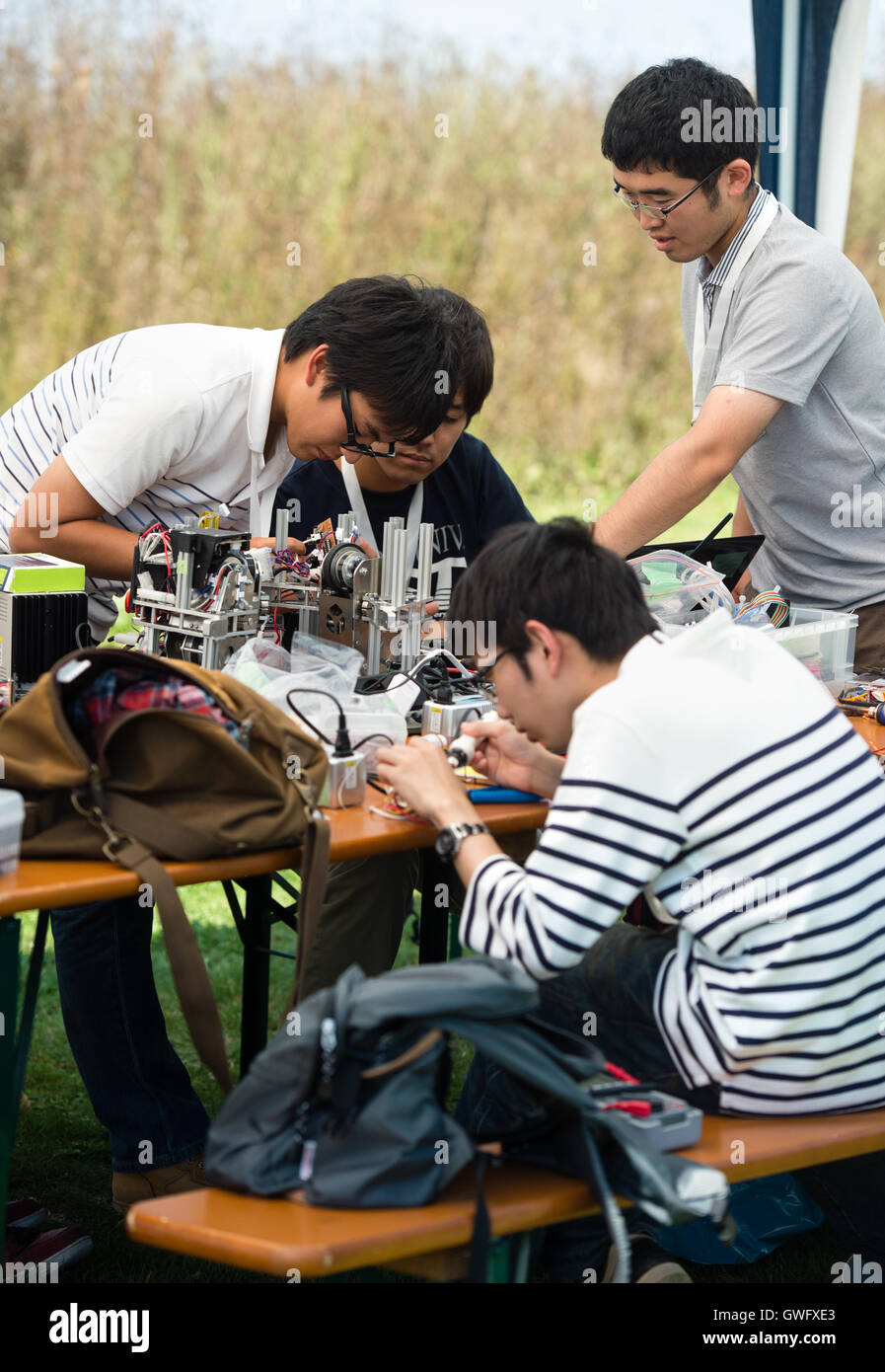 Garching, Germany. 13th Sep, 2016. The members of team 'Tryforce' from Japan at work during the European Space Elevator Challenge on the campus of the Munich Technical University in Garching, Germany, 13 September 2016. For the competition, the teams have developed small 'space elevators', which have to travel 100 metres along a rope up to a balloon. PHOTO: MATTHIAS BALK/DPA/Alamy Live News Stock Photo