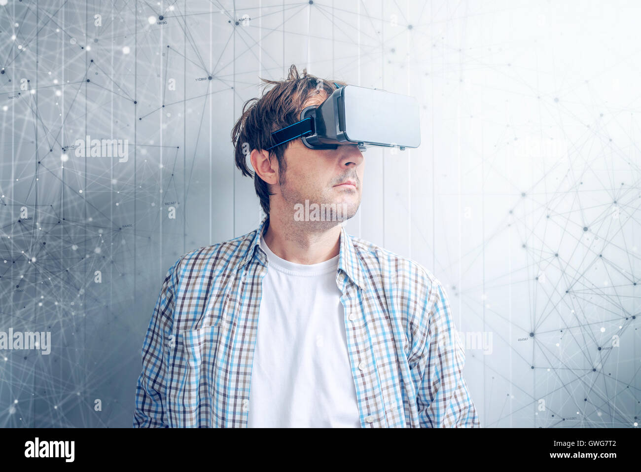 Guy with VR goggles watching 3d multimedia content Stock Photo Alamy